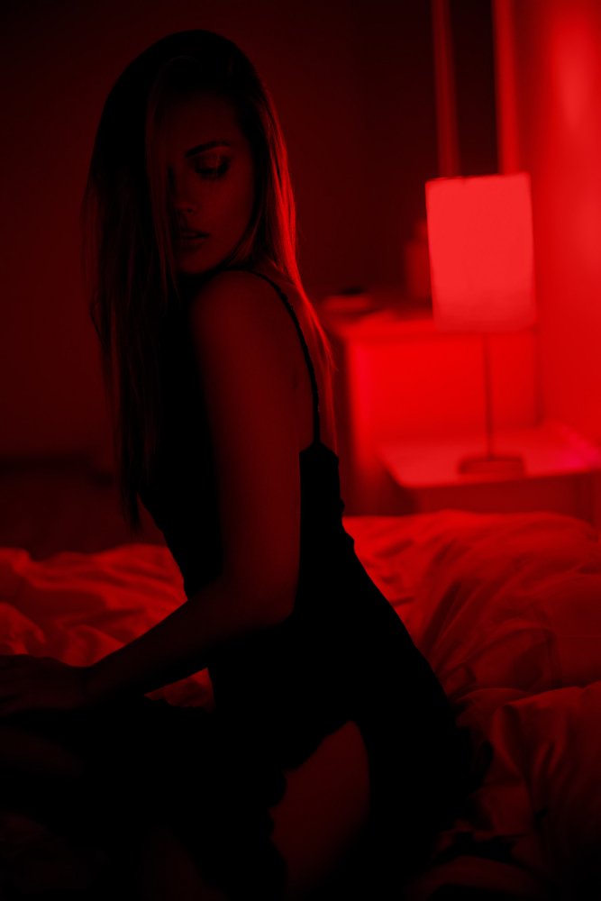 dark-photo-sexy-beautiful-brunette-woman-sitting-bed-black-dress-posing-red-interior